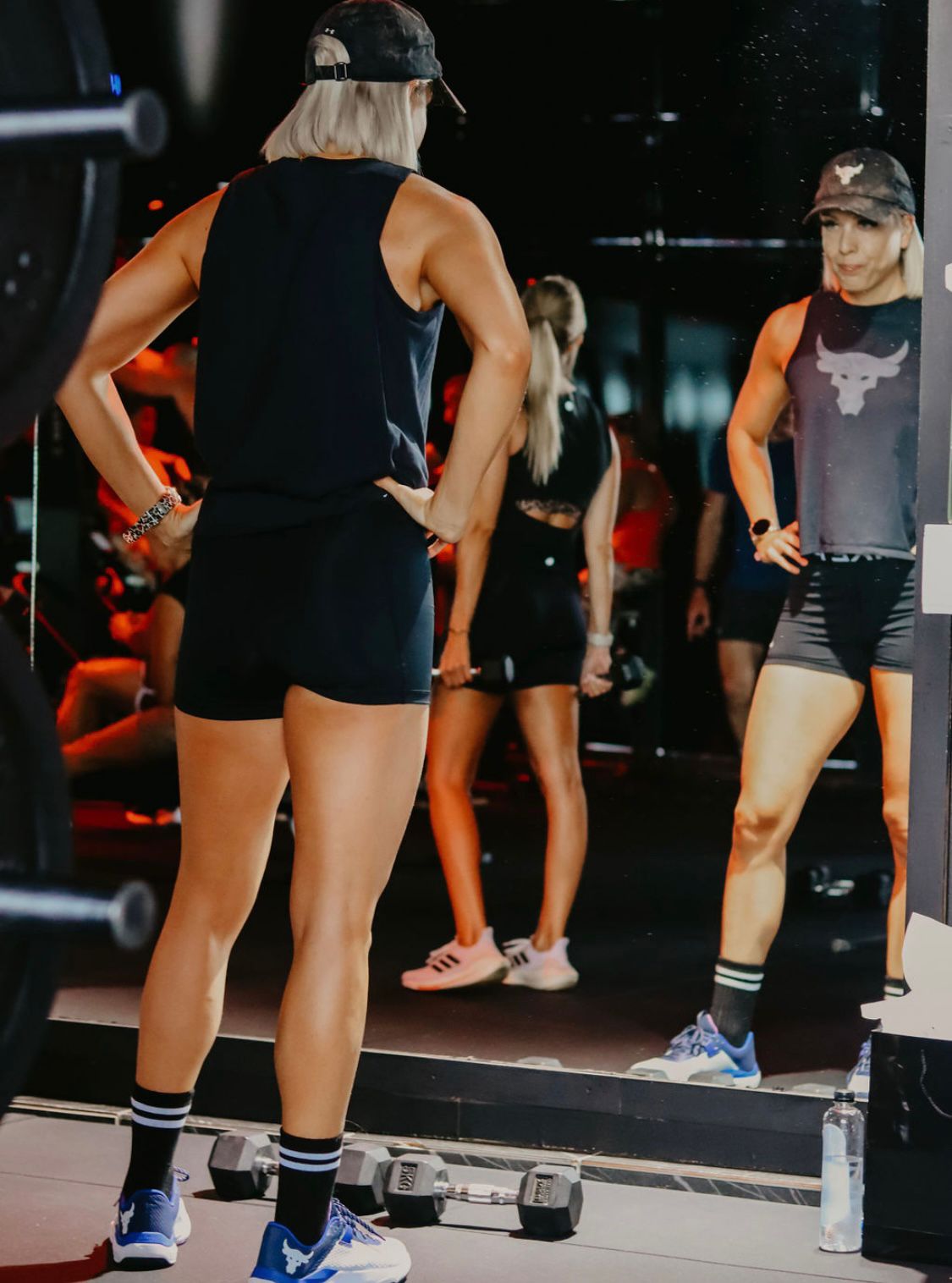 Member training in front of full-length mirror